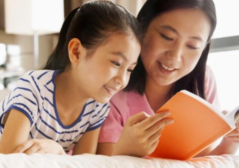 mother reading to daughter
