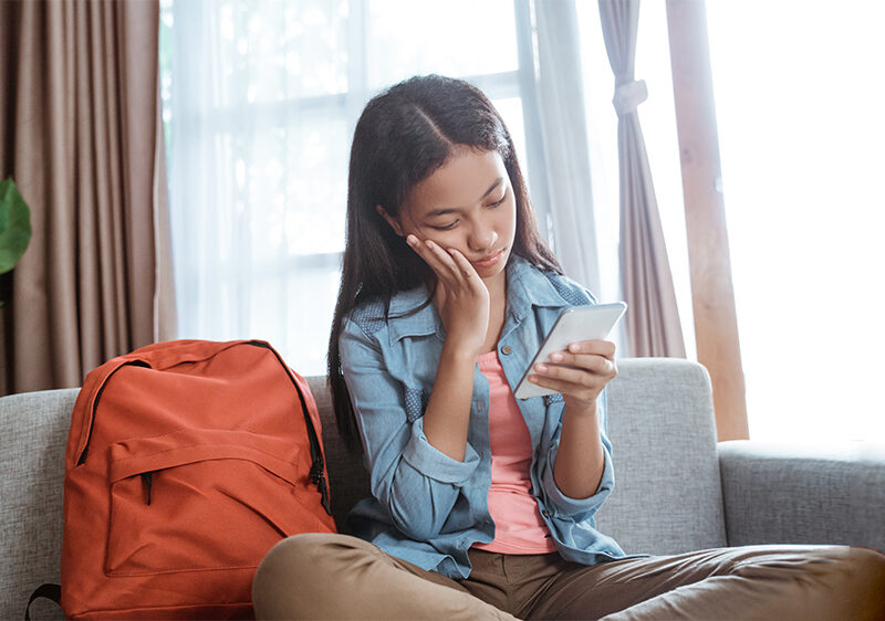 teenage girl holding a phone