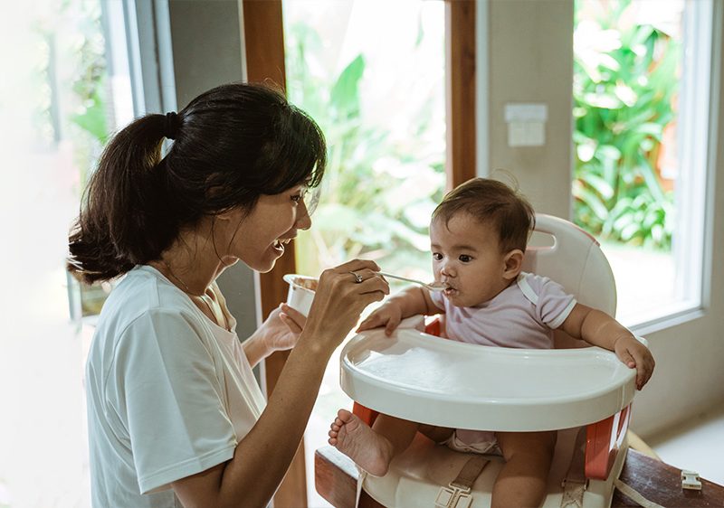 babysitter feeding baby